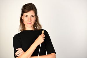 Chloé van Soeterstède stands in a black top with conductors stick