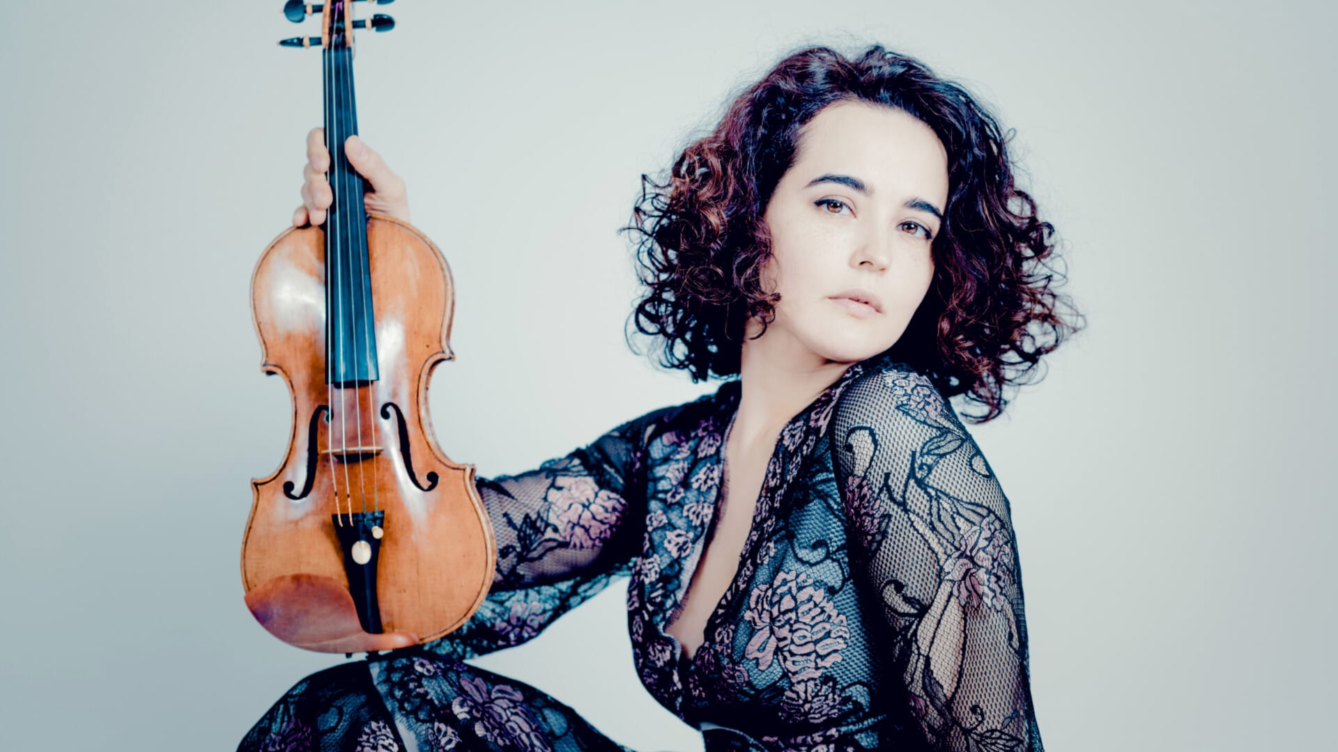 Violinist Alena Baeva sits with her violin