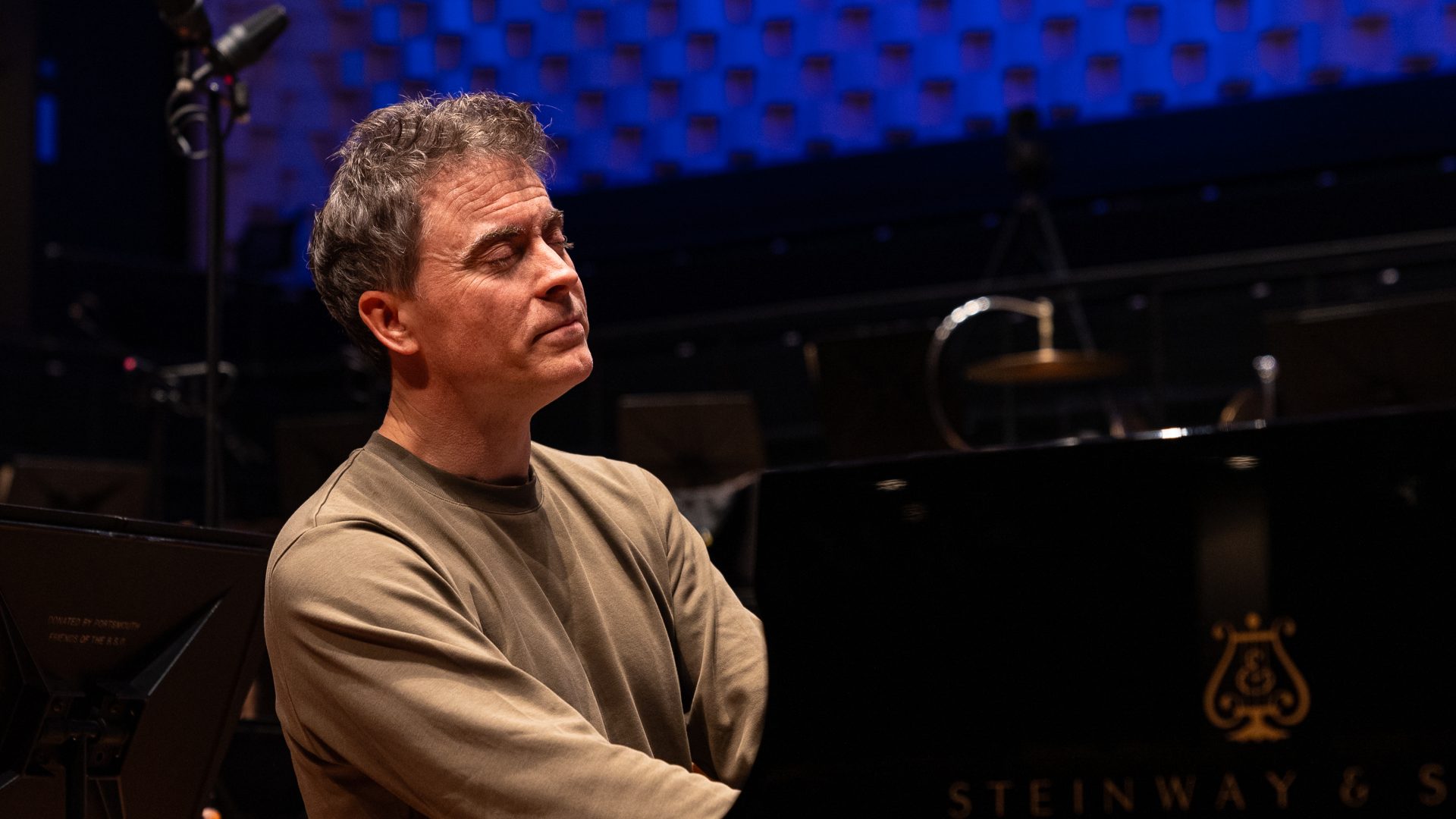 pianist Paul Lewis playing with his eyes closed during rehearsal.