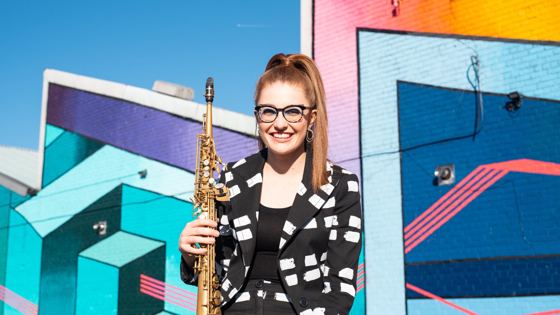 Saxophonist Jess Gillam smiles to the camera