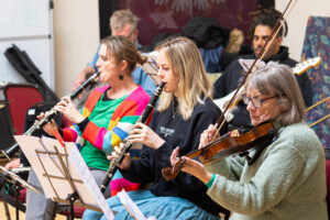 Musicians from Bristol Recovery Orchestra play violins and clarinets