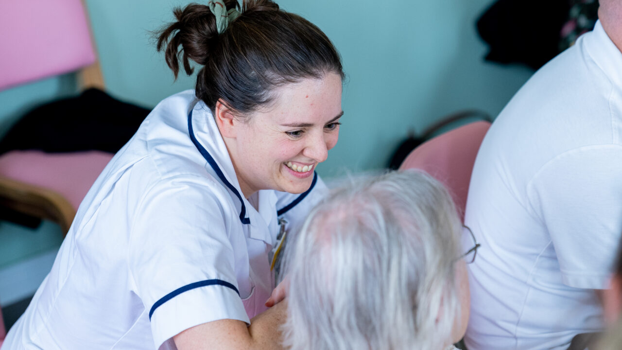 A nurse on DCH's dementia ward watches as a patient tries an instrument