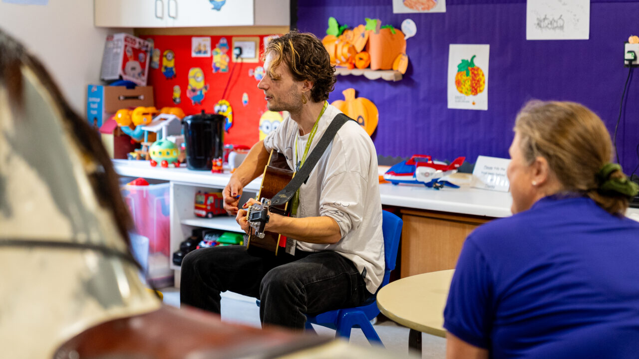 Guitarist Ed playing on a children's ward