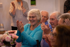 Attendees at a cake concert clap along to concert